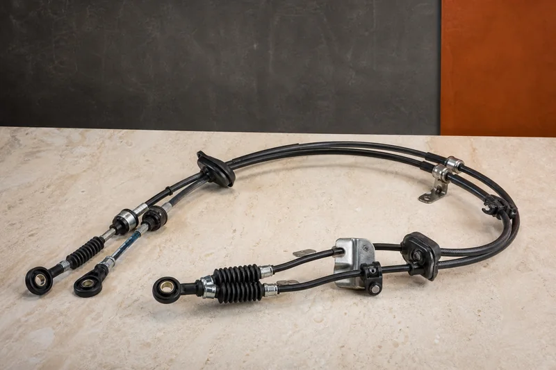 Physical pair of mechanical selector cables with sheaths, eyelet ends, brackets, clips and firewall grommets